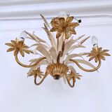 Vintage wrought iron chandelier decorated with golden and beige reeds