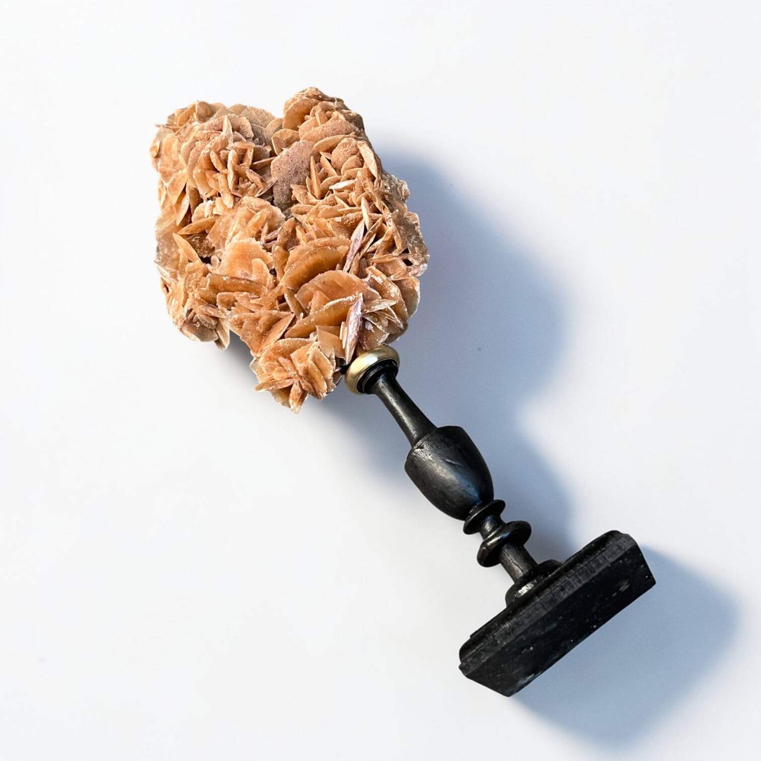 Sand rose on a turned black wooden base, late 19th century curiosities.