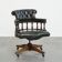 Adjustable green leather and wood Chesterfield office chair with swivel