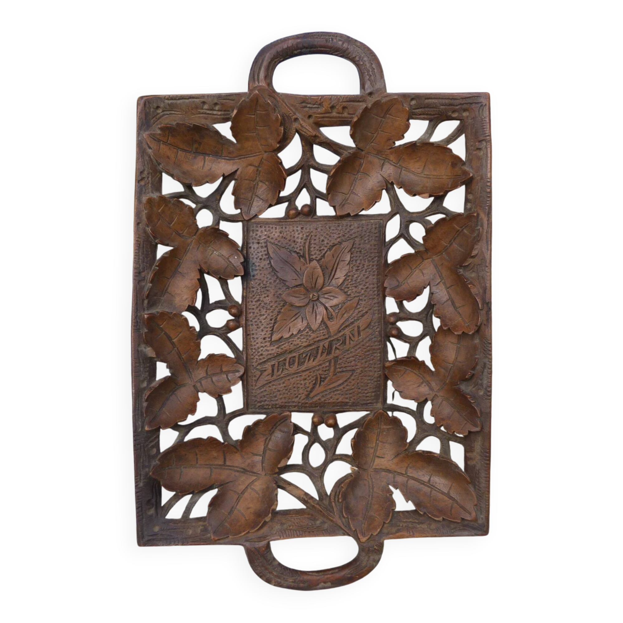 Small wooden tray cut out with leaf patterns