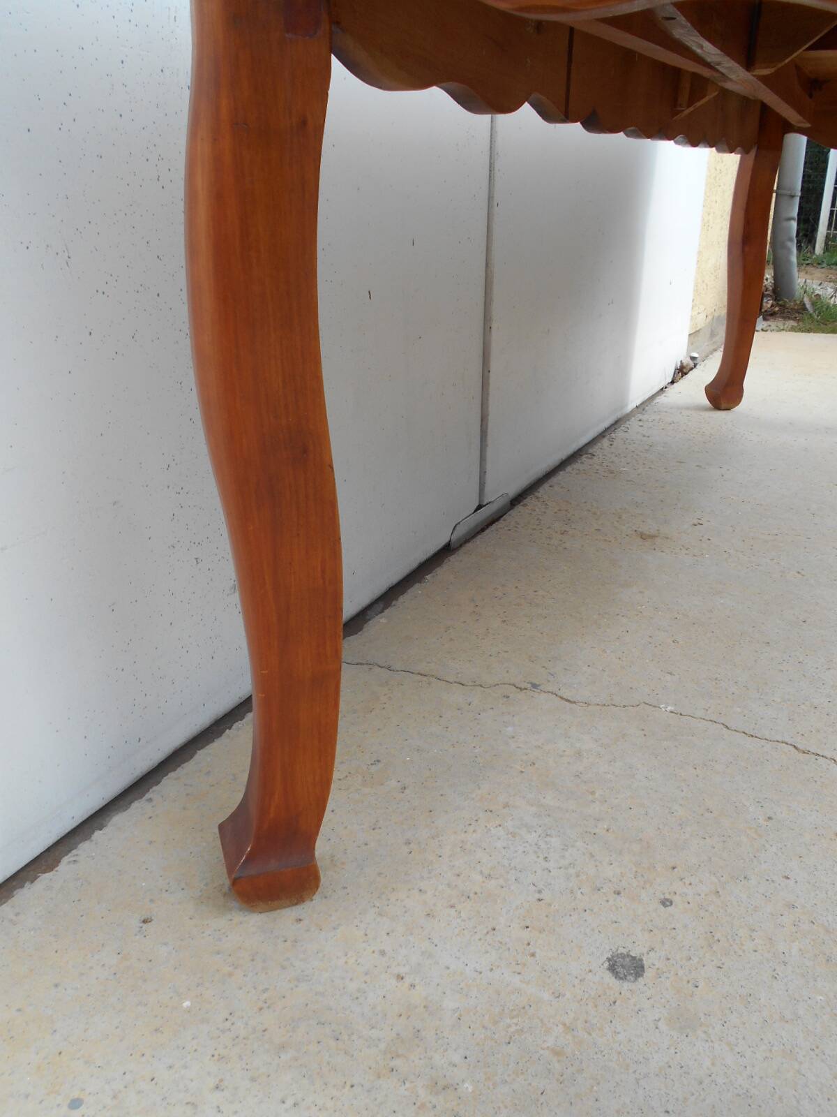 Large solid wood table with integrated extensions.