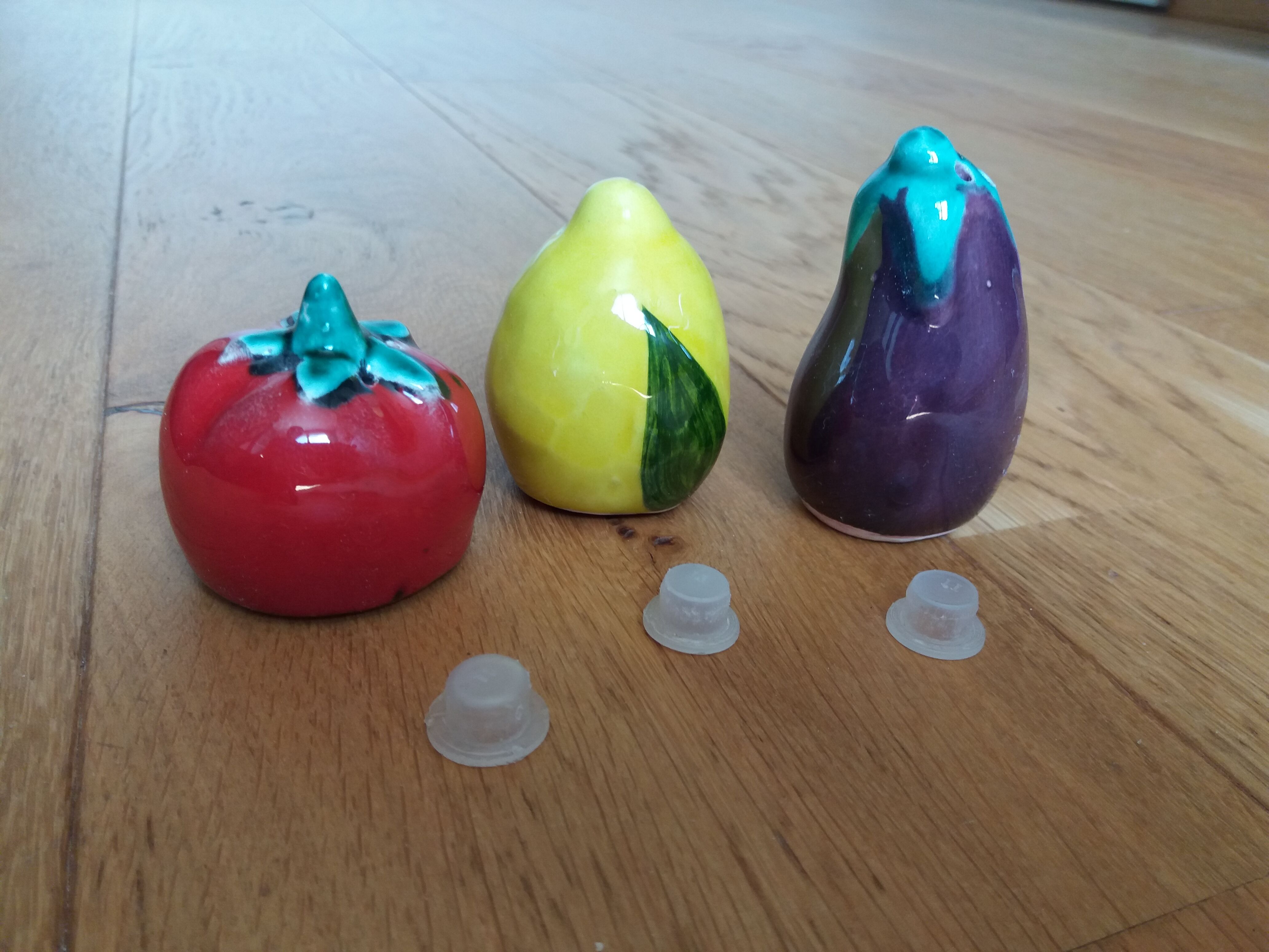 Trio salt shakers pepper vegetables and fruits in slip