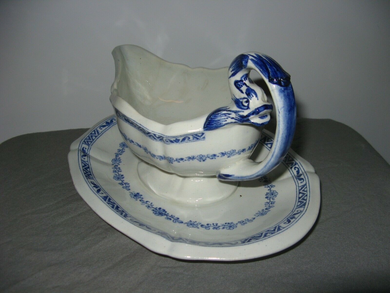 Saucière in Gien earthenware anse in the shape of a dolphin decoration garland 1900