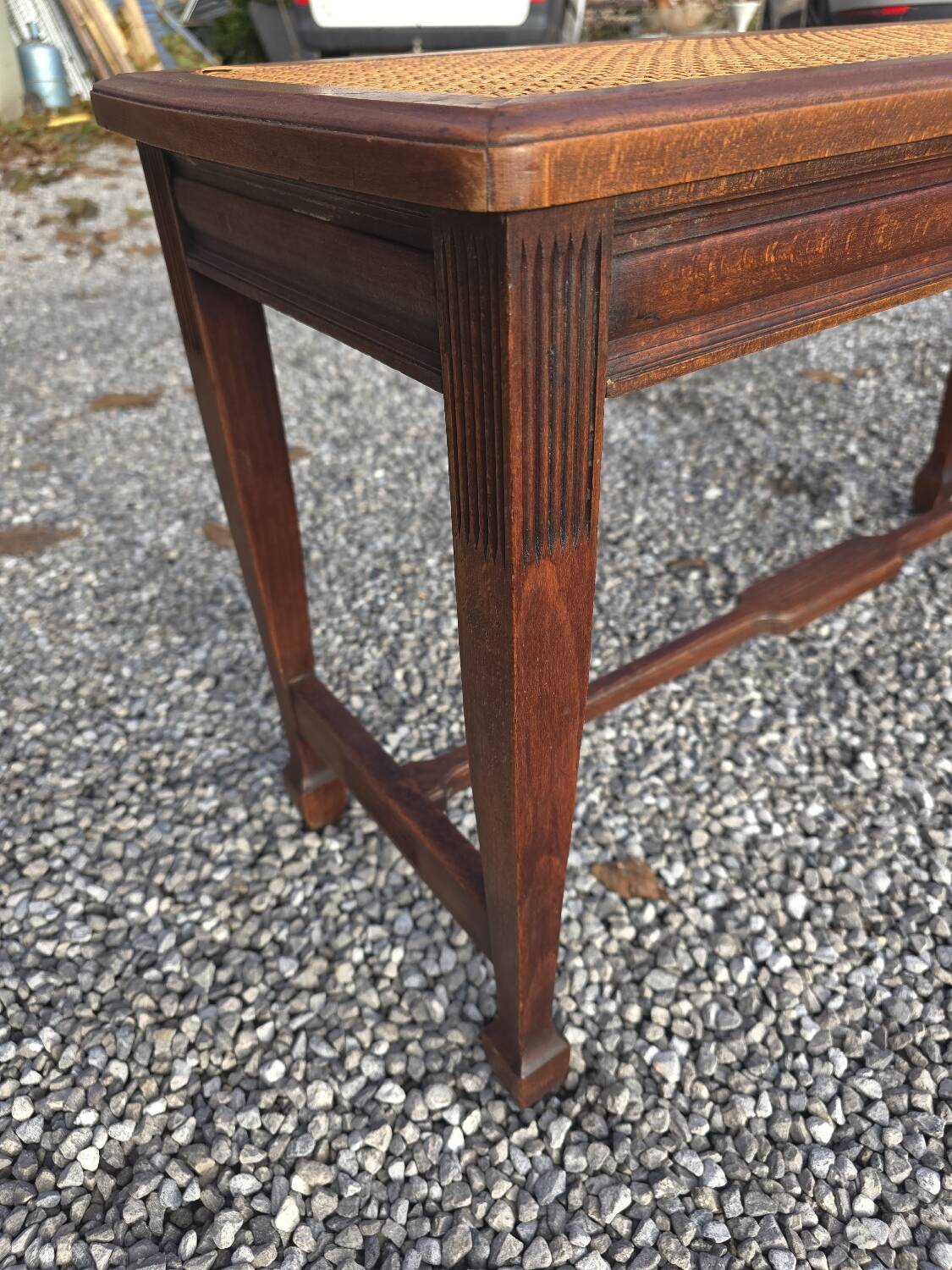 Beechwood piano bench with caning on the seat