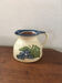 Terracotta jug with grape decoration.