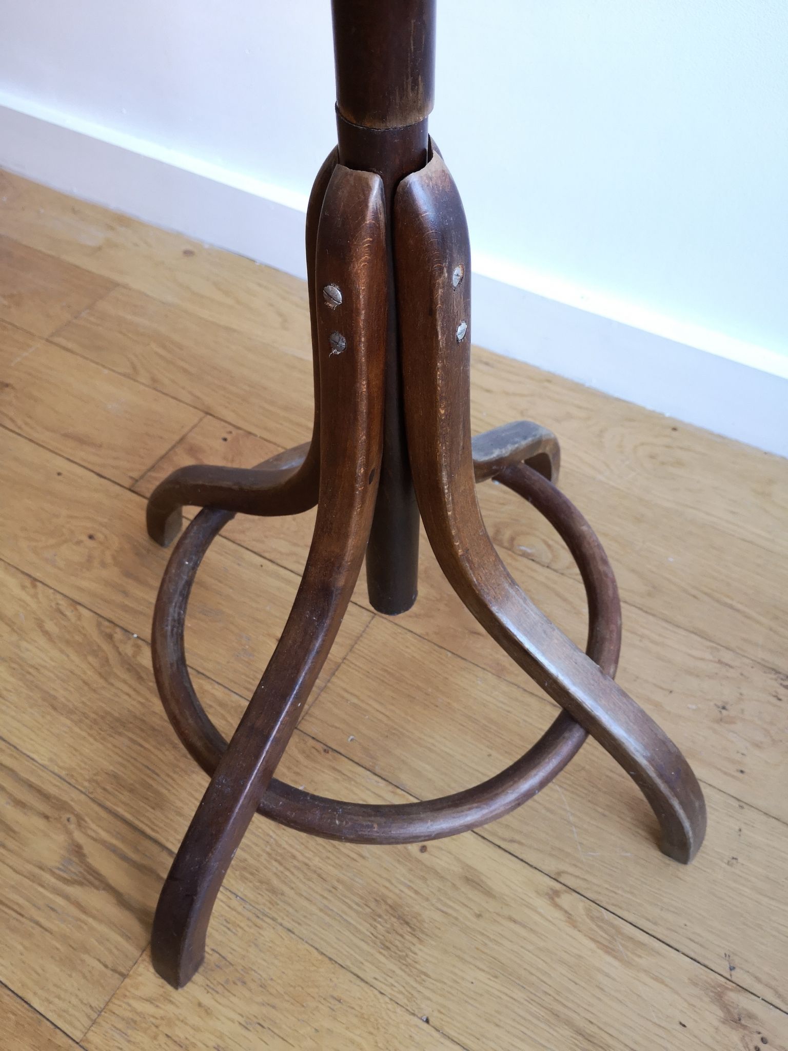 Dark wooden parrot coat holder