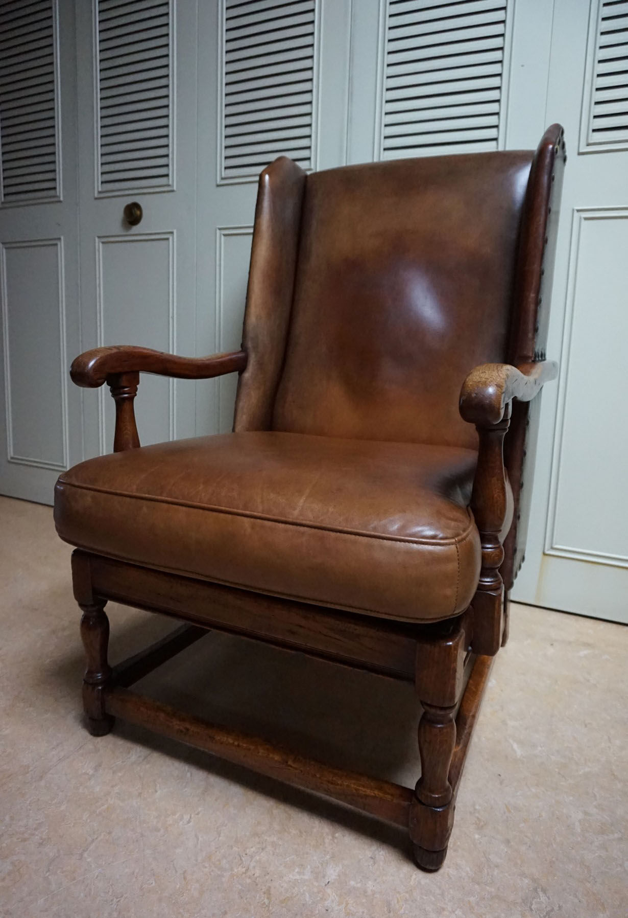 English high back cognac leather wingchair by Criterion cord