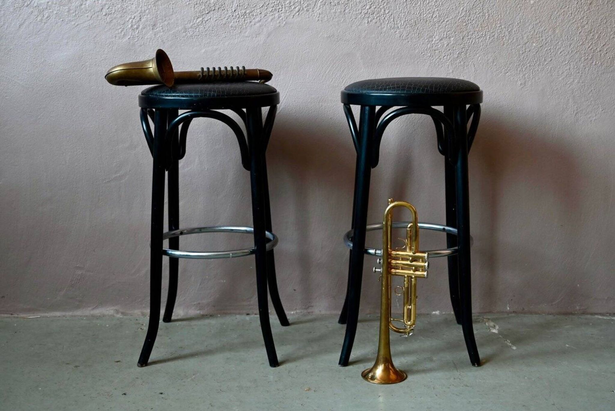 Pair of 1960s bistro bar stools in black and chrome with vinyl shell.
