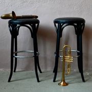 Pair of 1960s bistro bar stools in black and chrome with vinyl shell.