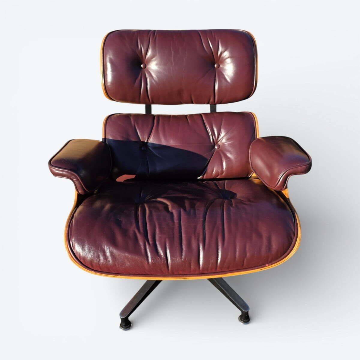 Original Eames lounge chair by Herman Miller in burgundy rosewood.