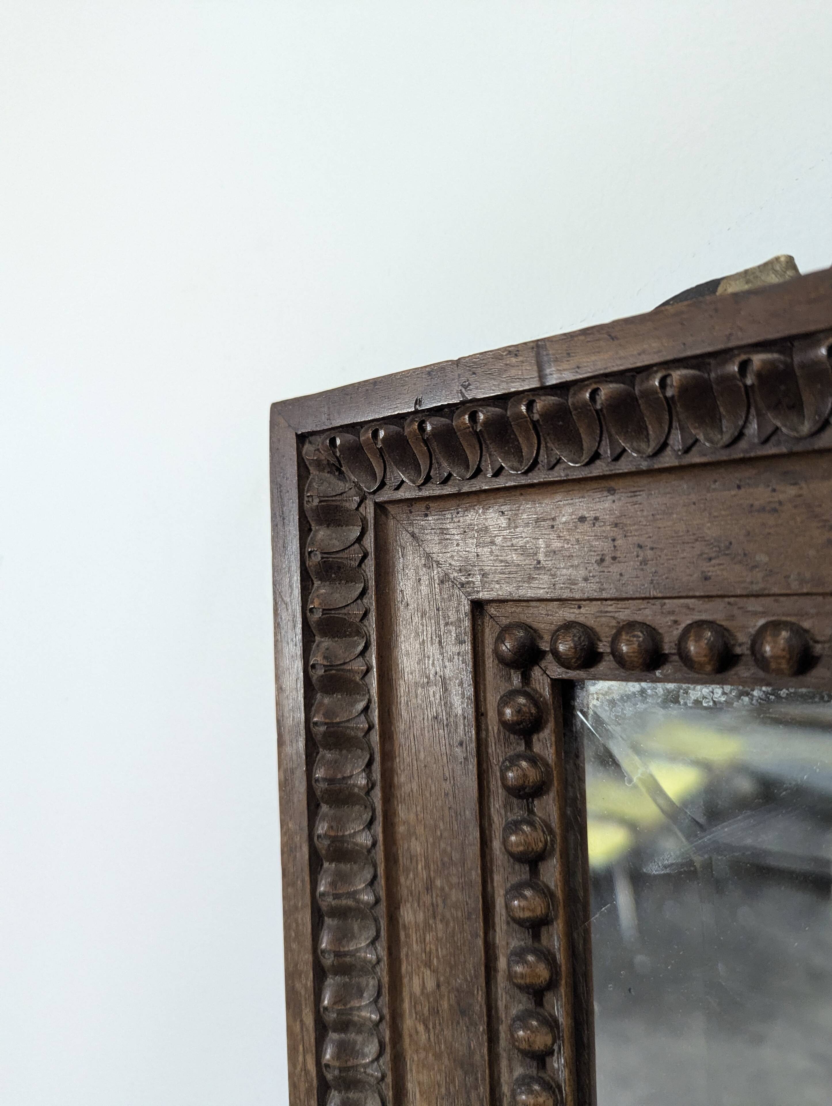 Louis XVI style mirror in carved walnut.