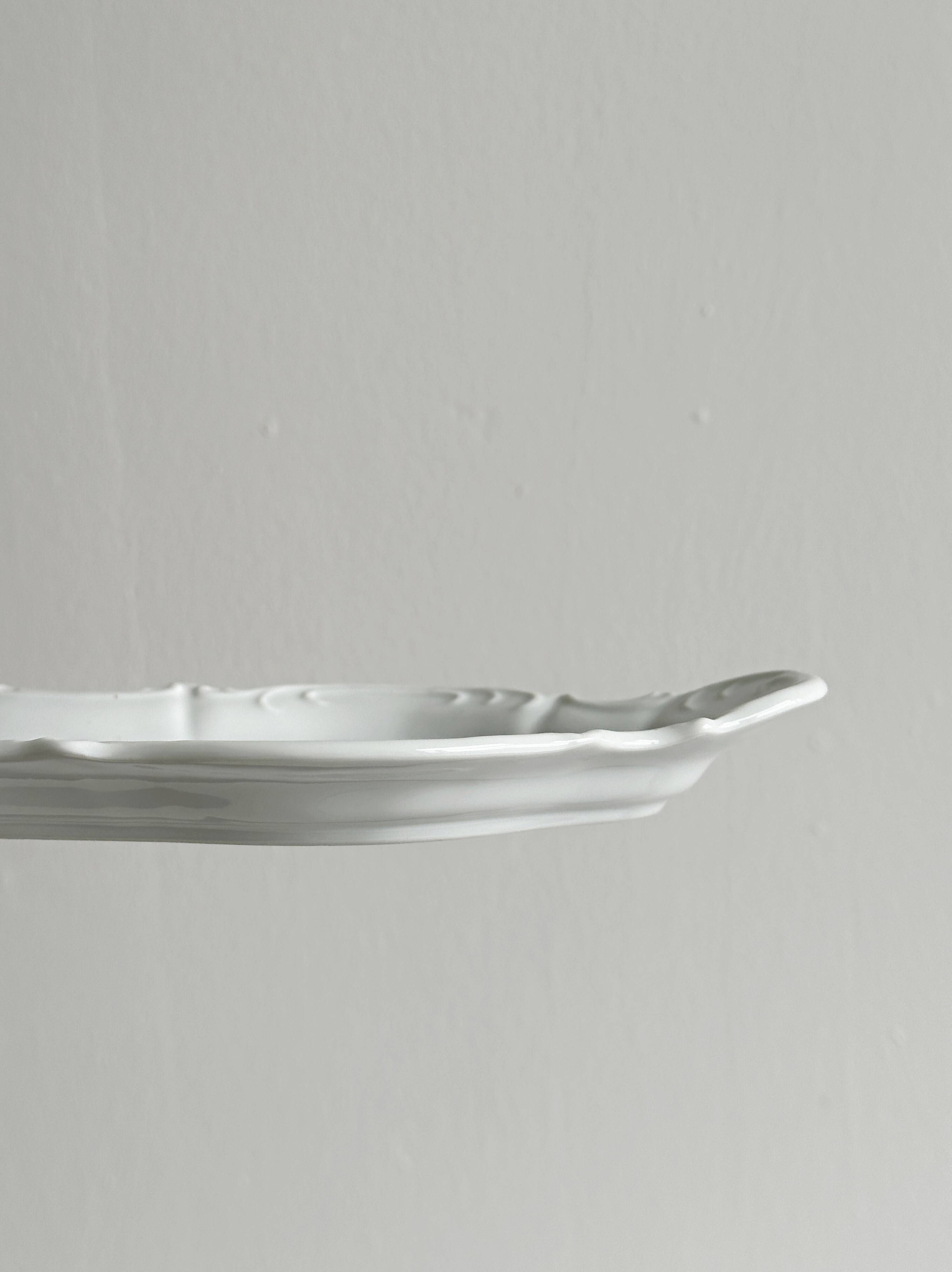 white porcelain plate in an unusual shape