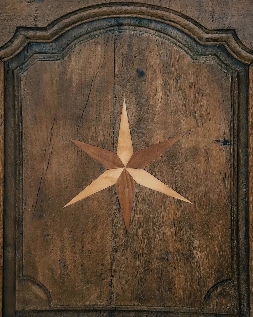 Antique French rustic wardrobe with star inlays.