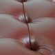In very good condition elegant red/brown chesterfield ottoman made of cow leather