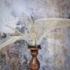 Table lamp, turned wooden foot, 8 rattan petals and golden mesh