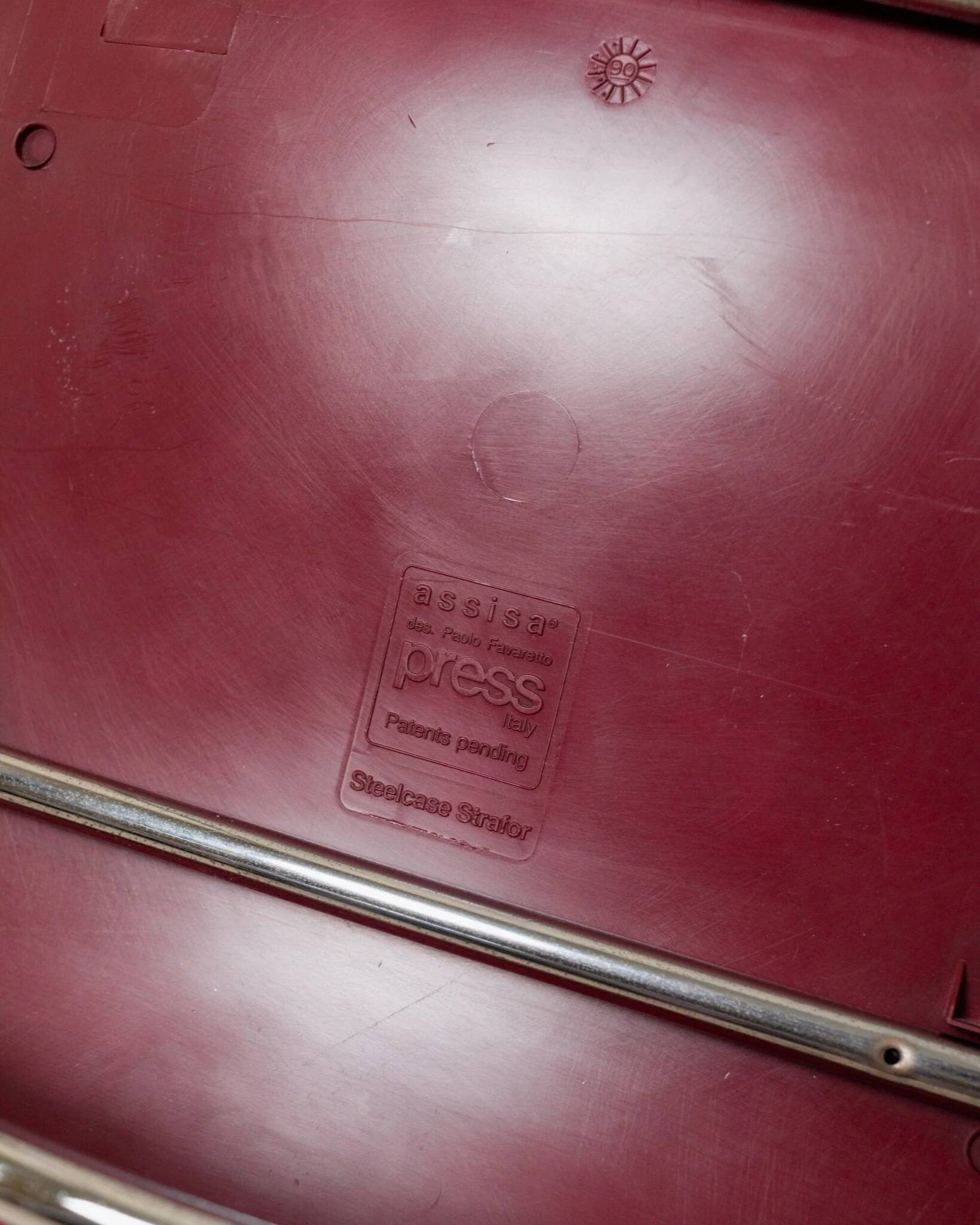 Red plastic-seat stacking chair with chrome frame by Paolo Favaretto for Assisa (Italy 1986) – vintage design