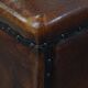 Cognac-colored sheepskin stool with decorative studs