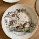 Polychrome ironstone dessert plates from Digoin and Sarreguemines.