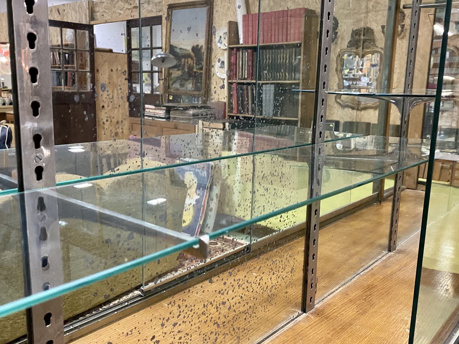 Store window with sliding doors in matte black patinated oak - 30s