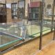 Store window with sliding doors in matte black patinated oak - 30s
