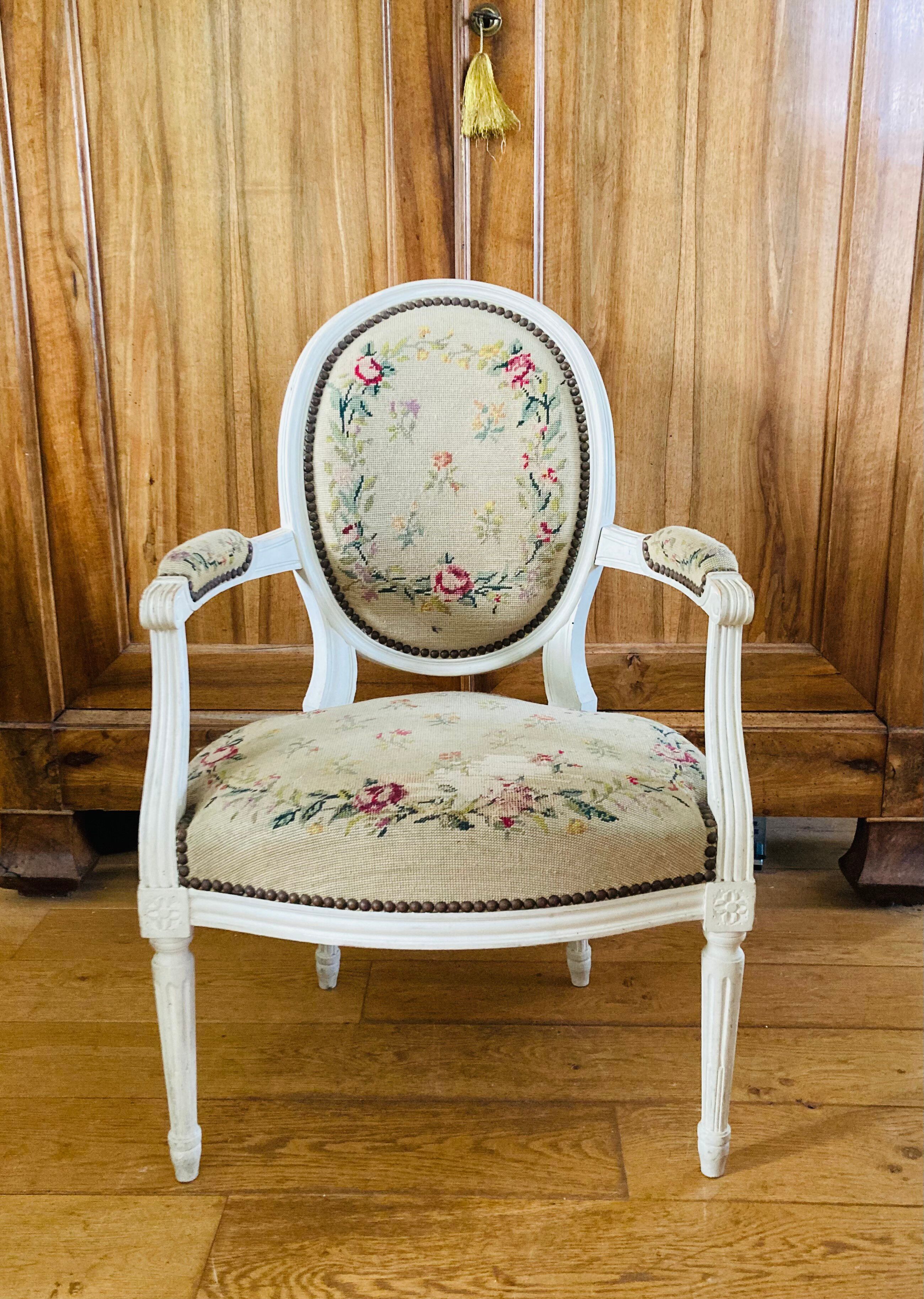 Upholstered armchair with cross-stitch in the Louis XVI style, 19th century.