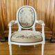 Upholstered armchair with cross-stitch in the Louis XVI style, 19th century.
