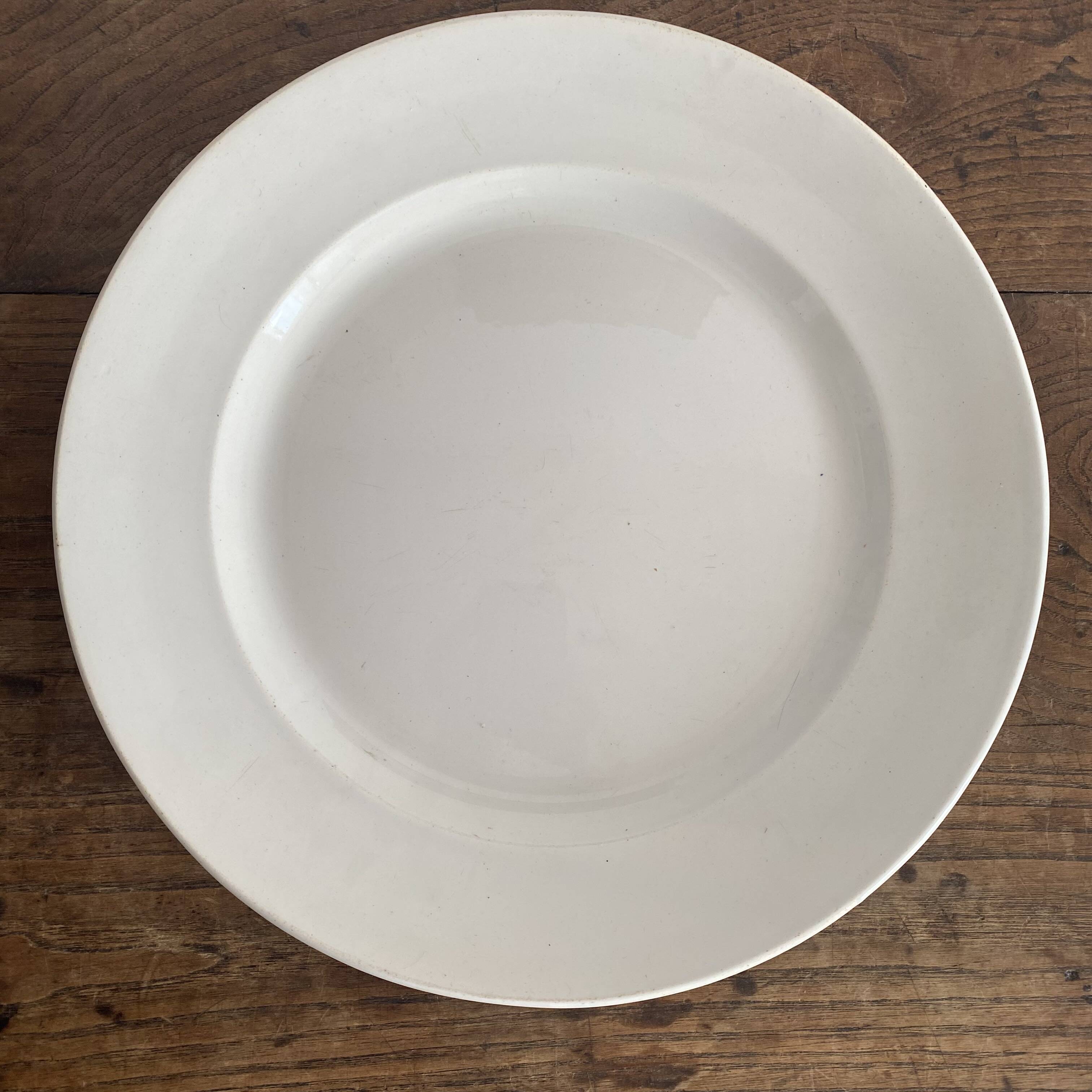 Set of large round white earthenware dishes from Creil and Montereau, 19th century