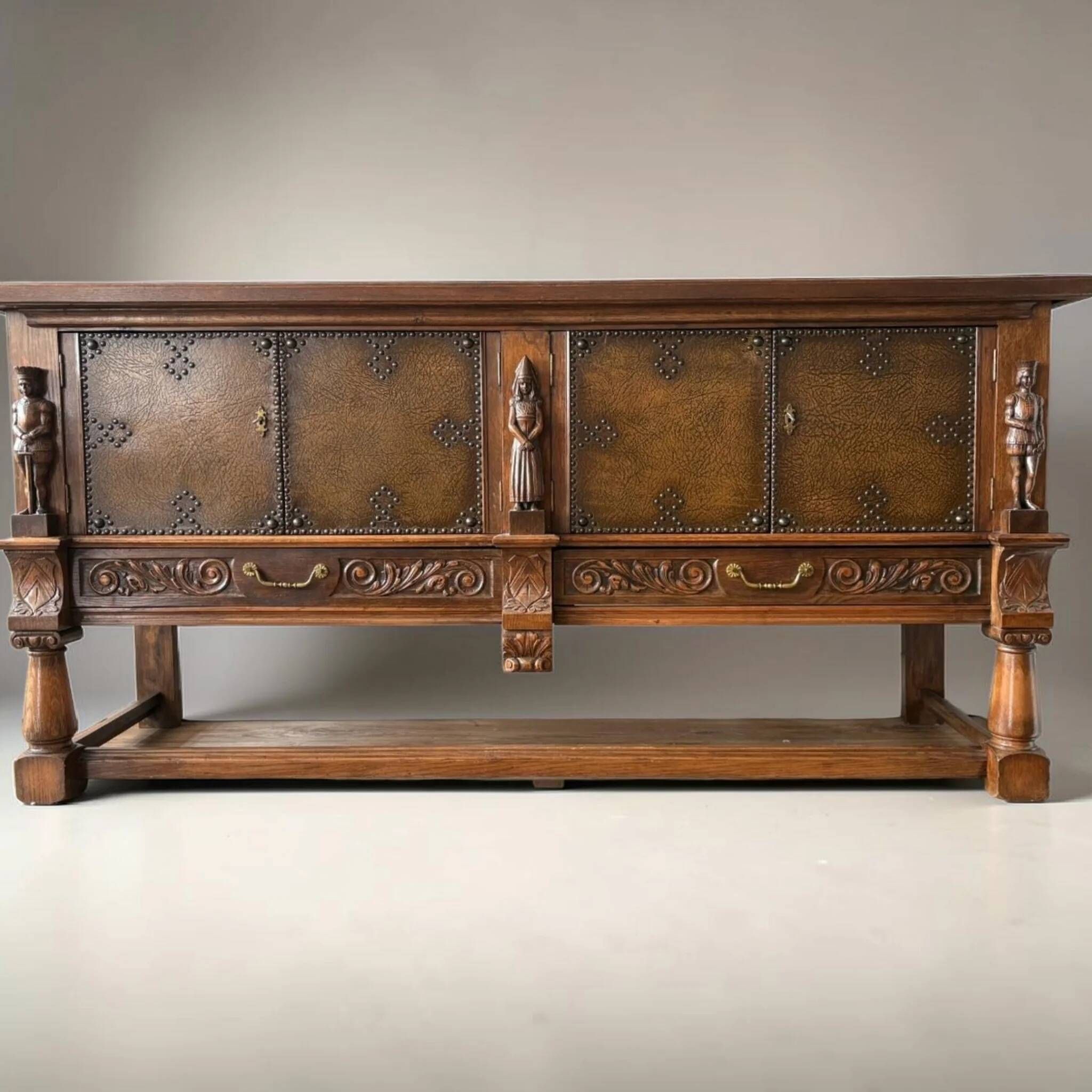 Mechelen Spanish sculptured sideboard / leather covered panels with decorated nails / 1960s