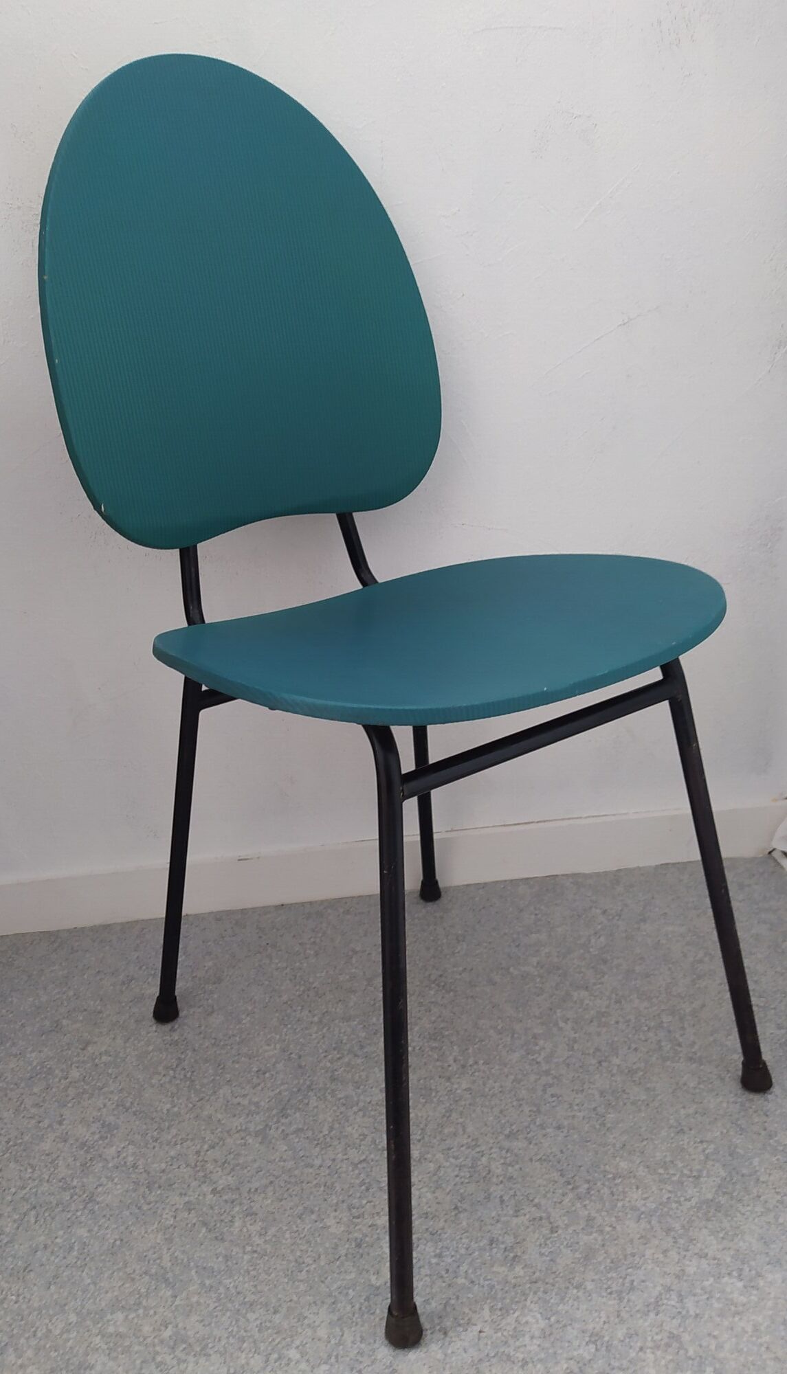 Vintage chair in turquoise green vinyl with black metal legs