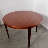 Round teak table with Scandinavian design extensions from the 60s vintage