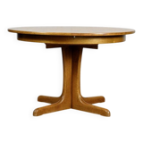 Round teak table with an extension.