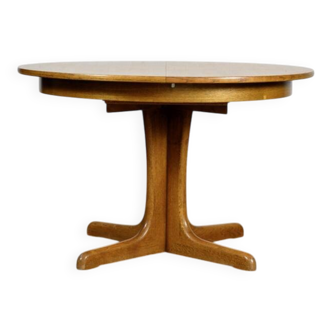 Round teak table with an extension.