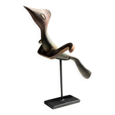 Traditional Indonesian decorative wooden bird on a base, crest model.