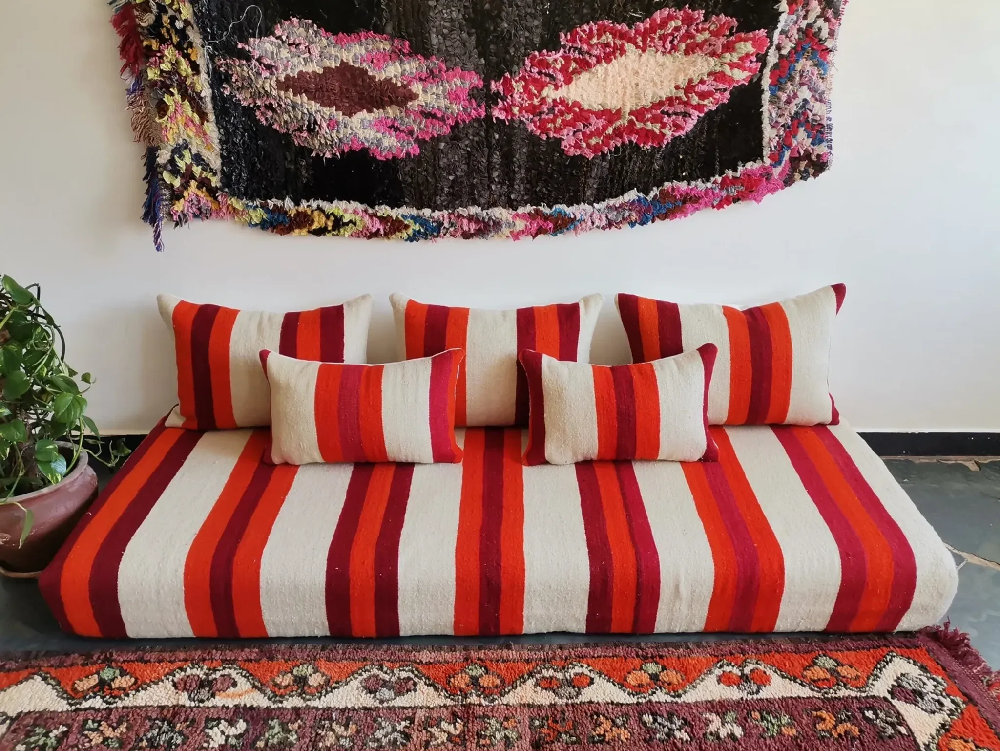 Set of covers for cream and red Moroccan floor sofa.
