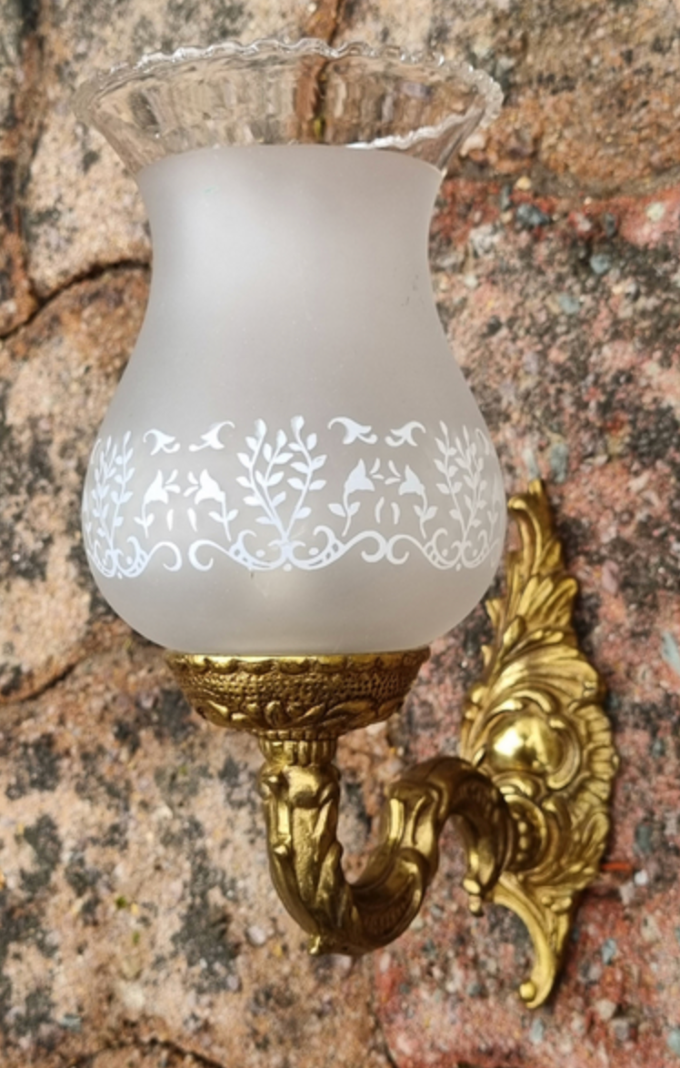 Pair of bronze wall lamps and frosted glass globe, early twentieth century.