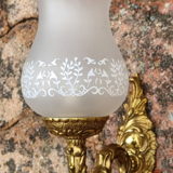 Pair of bronze wall lamps and frosted glass globe, early twentieth century.