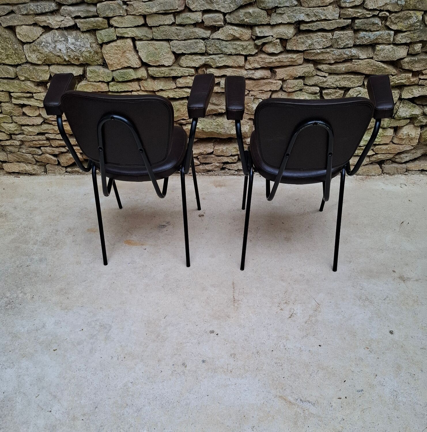 Brown faux leather armchairs