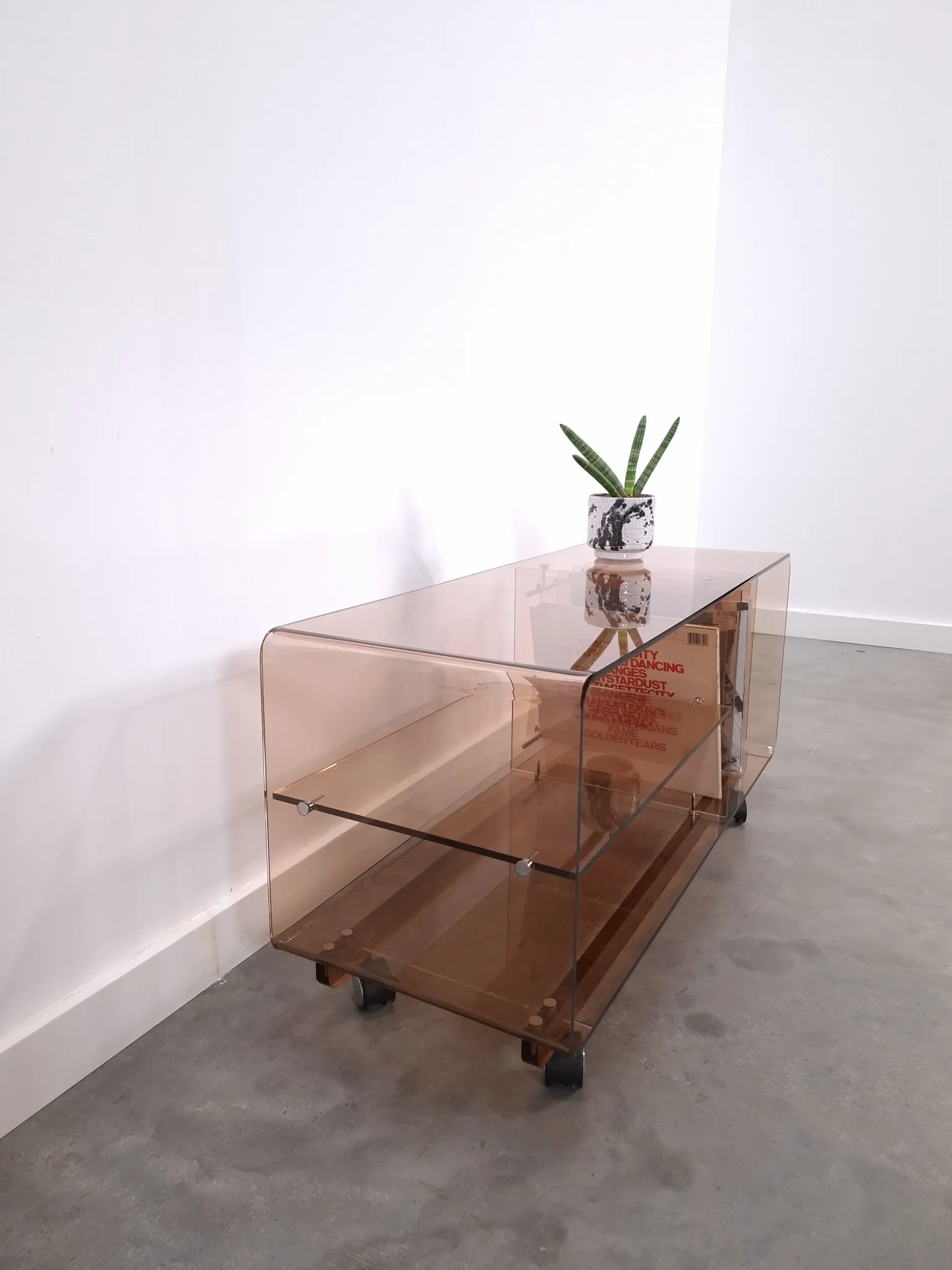 Vintage hifi, LP cabinet, TV unit made of tinted plexiglass on wheels, records.