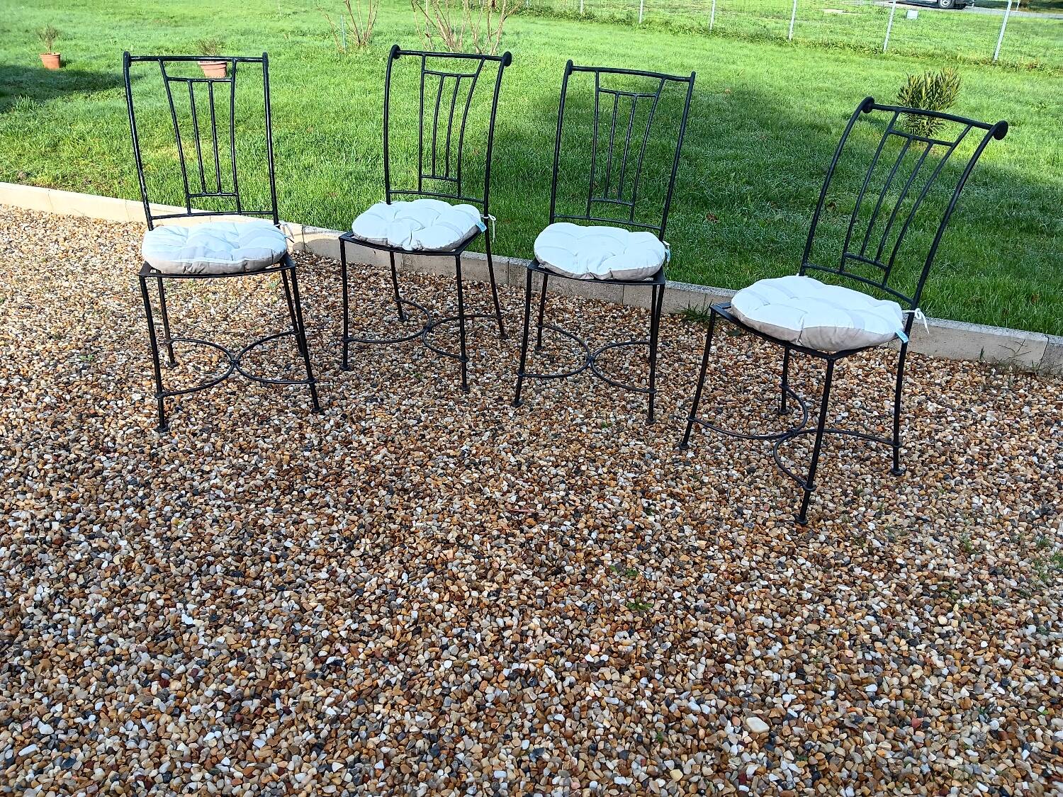 Wrought iron chairs with cushions