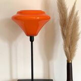 Table lamp with a vintage orange glass globe and a gold base
