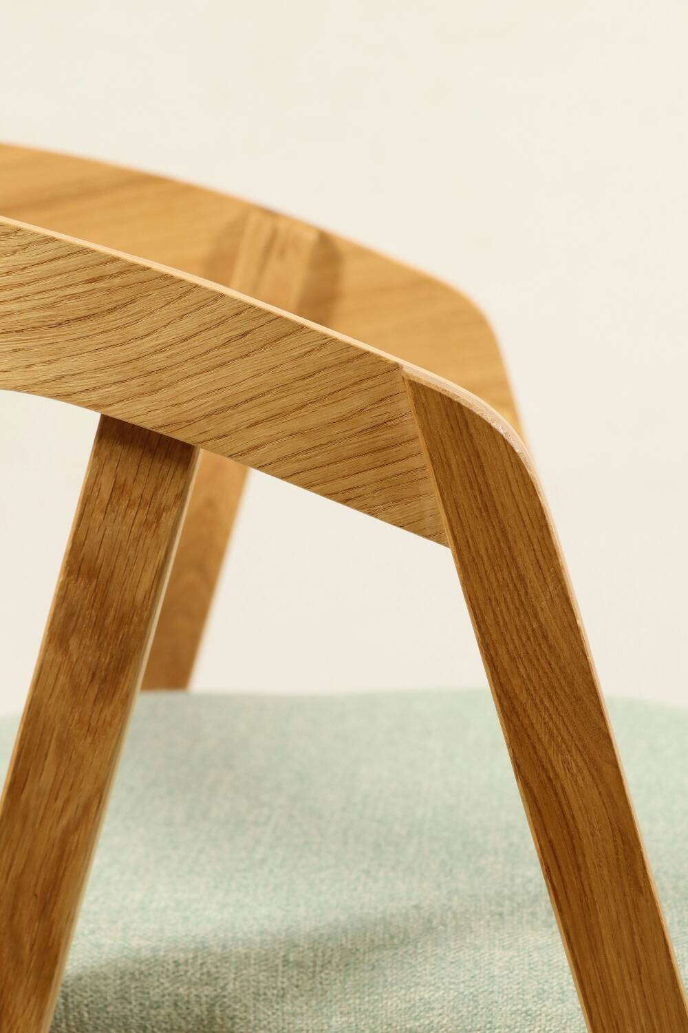 Vintage dining chair in light oak with natural linen pastel green fabric.