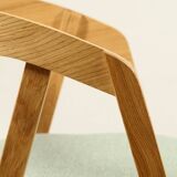 Vintage dining chair in light oak with natural linen pastel green fabric.