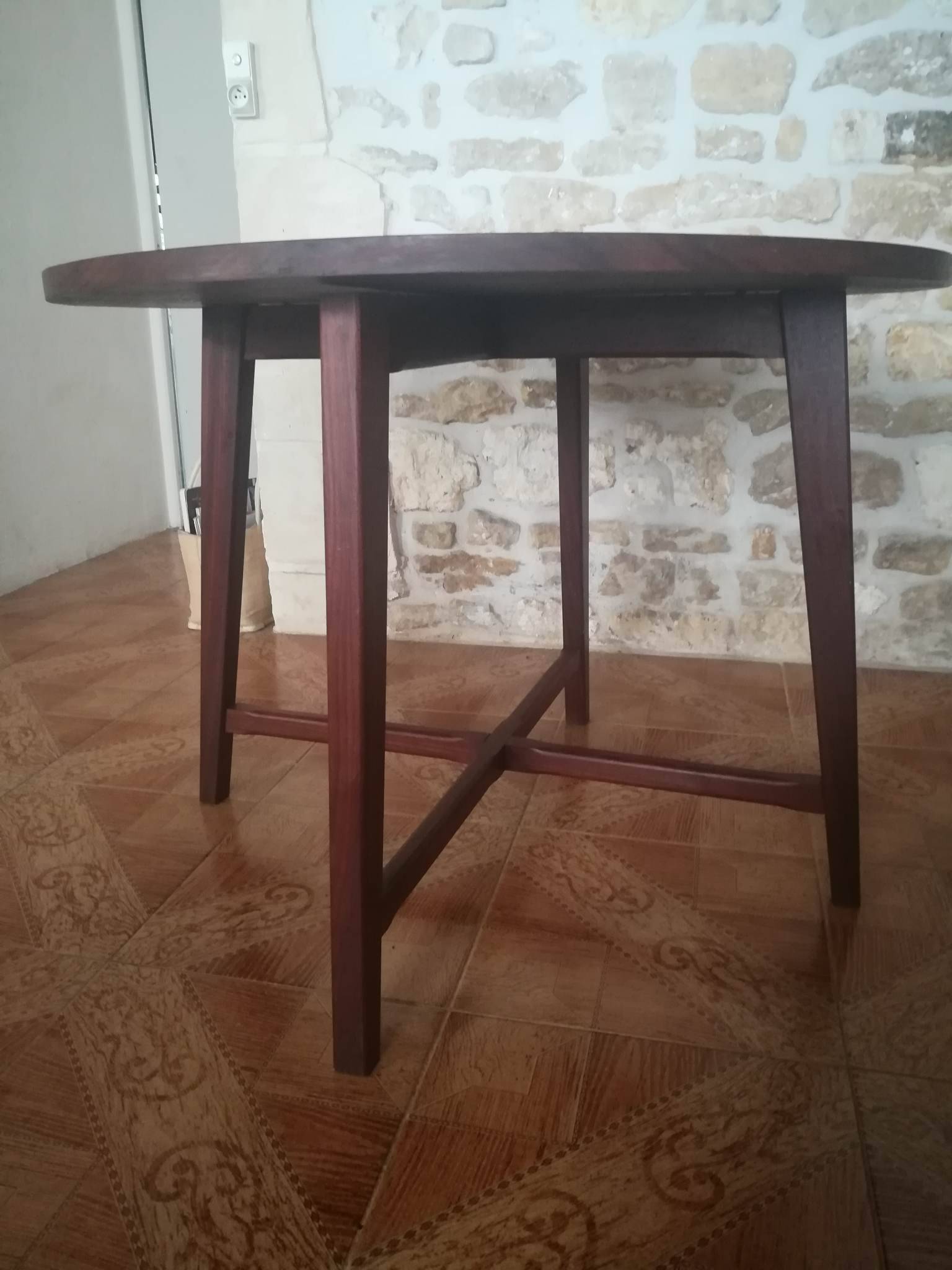 Round wooden table with thin legs