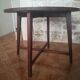 Round wooden table with thin legs