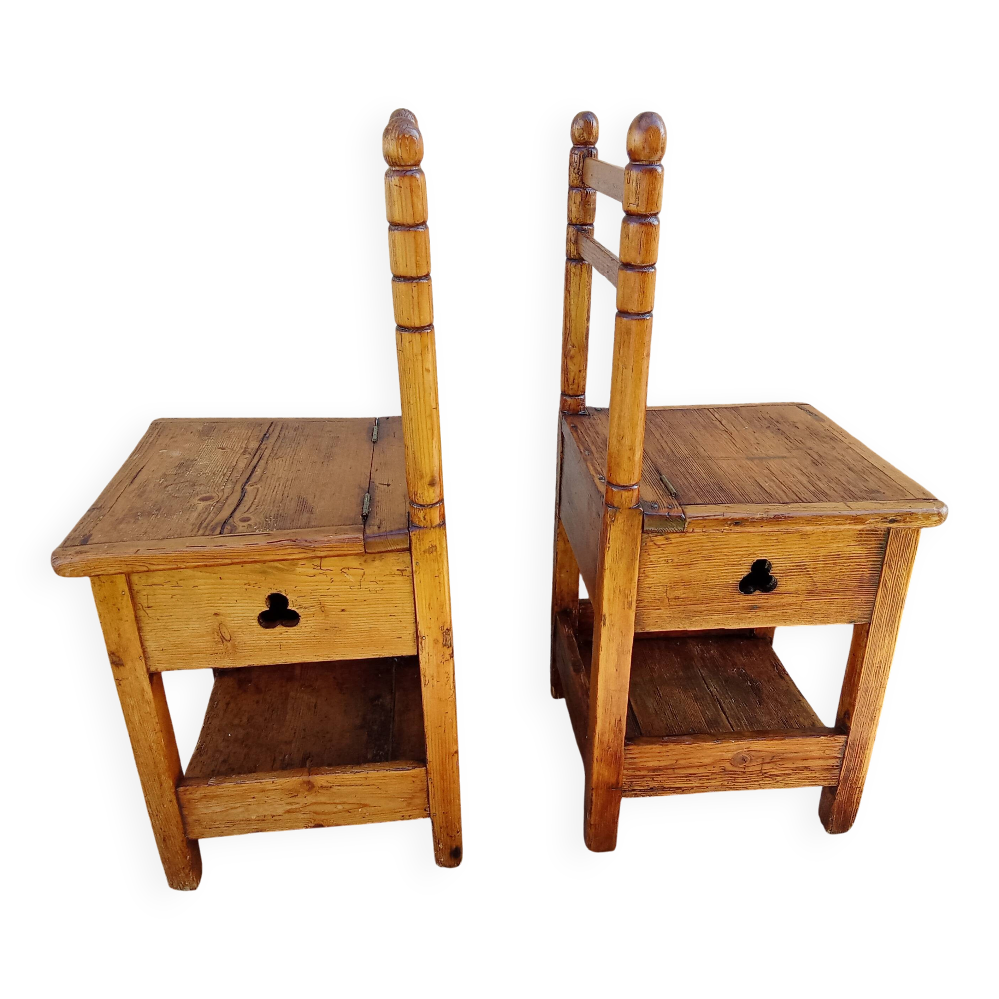2 old wooden children's chairs with a small chest.