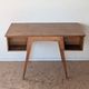 1950s oak double-sided desk with compass legs.