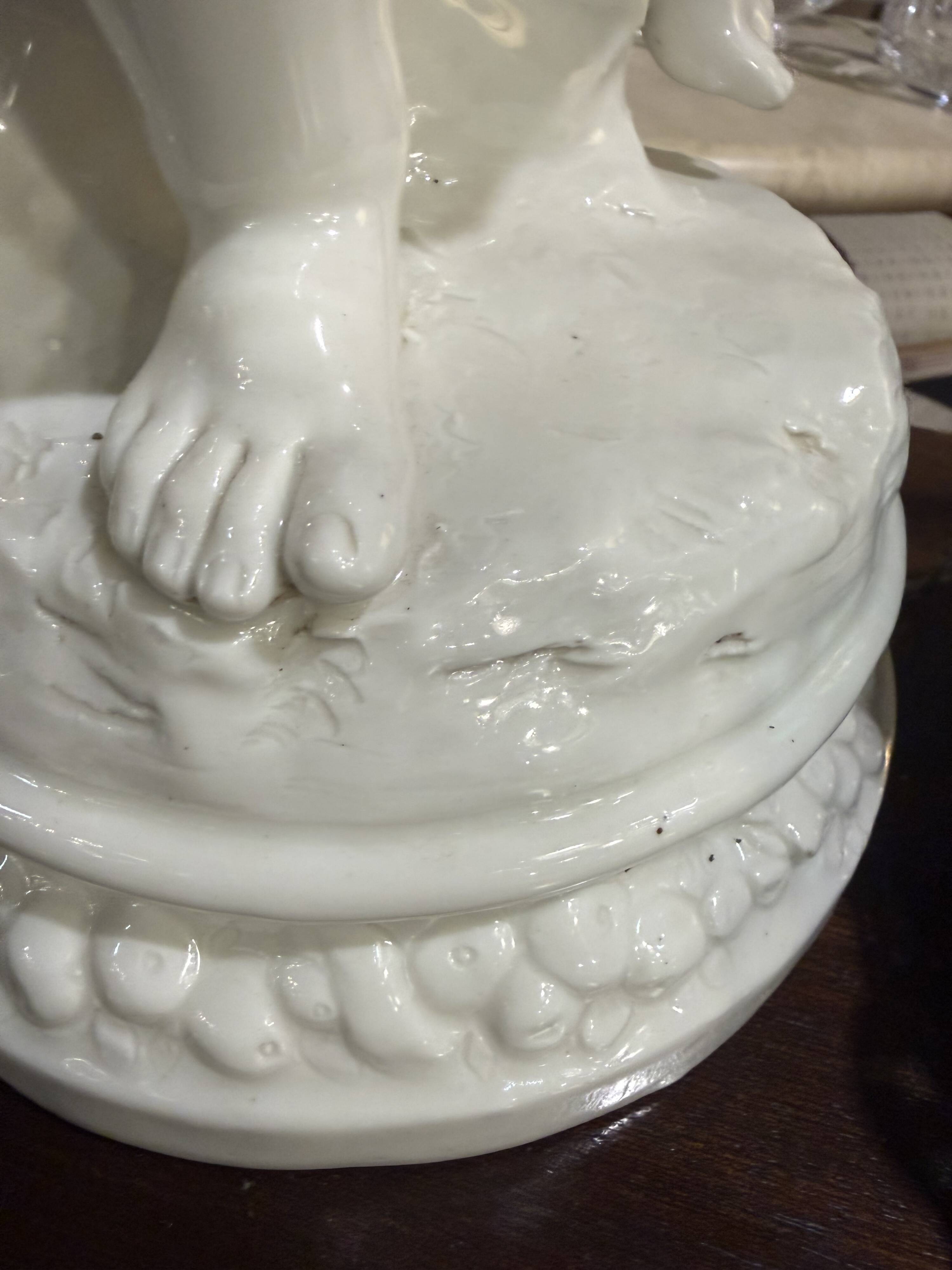 Child statue with flowers in porcelain, signed.