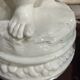 Child statue with flowers in porcelain, signed.