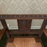 Antique armchair in carved wood and straw seat