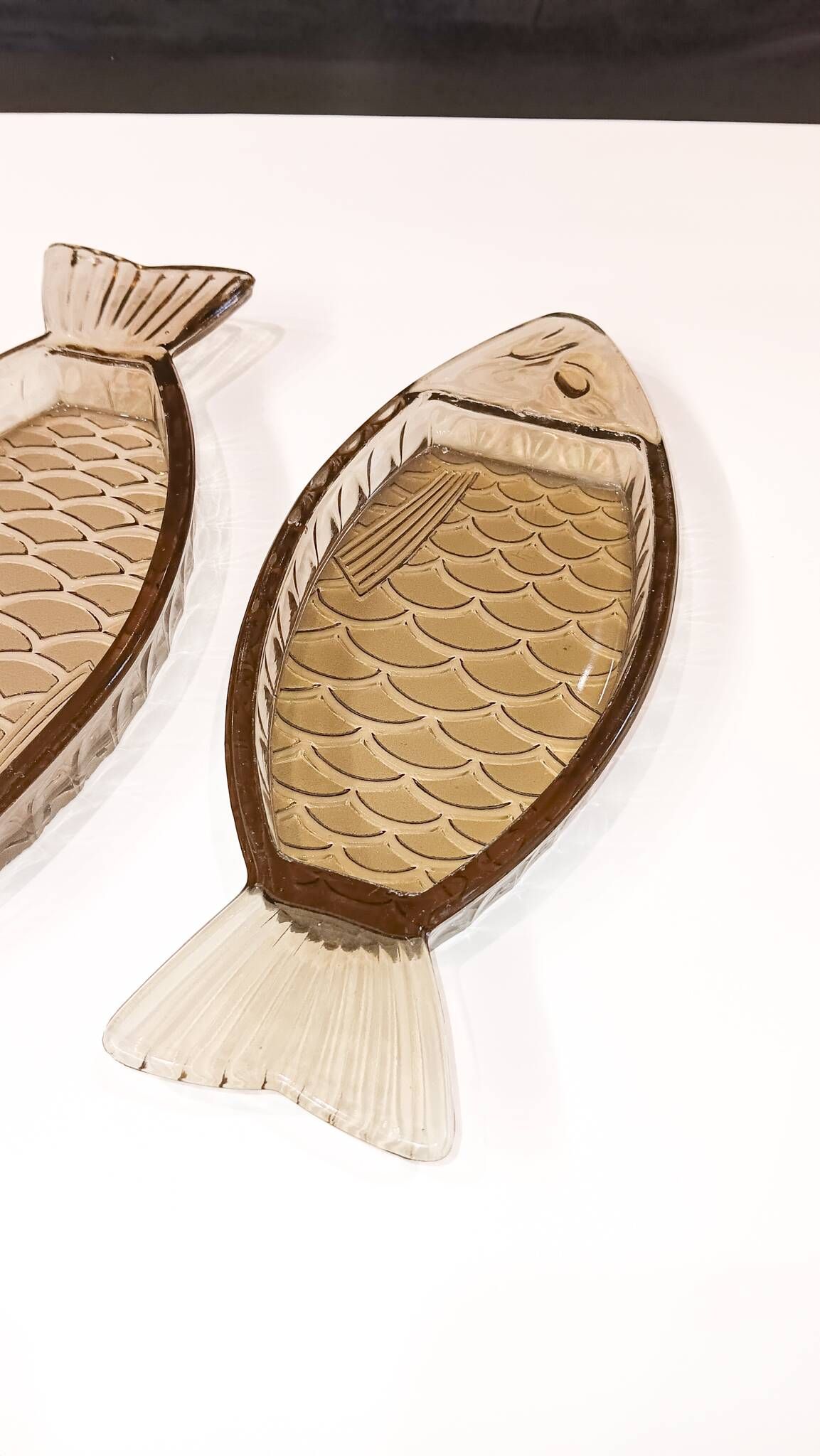 Set of 2 transparent smoked glass bowls in the shape of a fish.